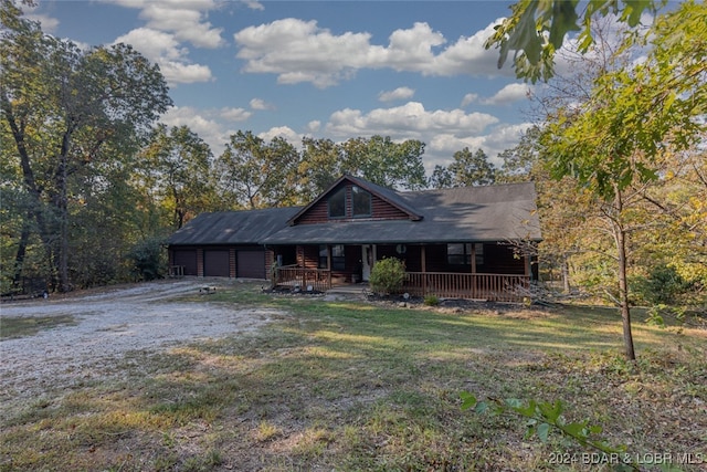 log cabin featuring a porch and a front lawn