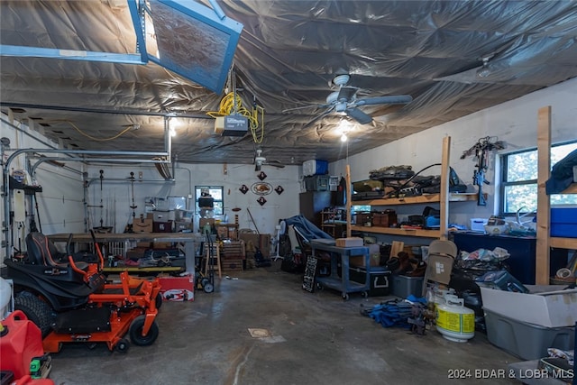 garage with a garage door opener, ceiling fan, and a workshop area