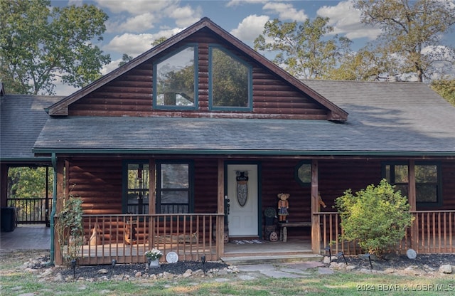 log-style house with a porch