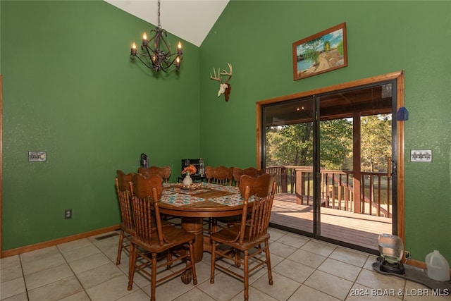 tiled dining room featuring high vaulted ceiling and a notable chandelier