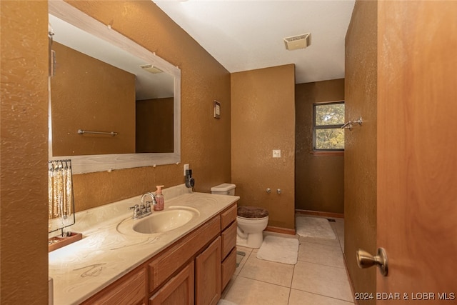 bathroom featuring tile patterned floors, vanity, and toilet