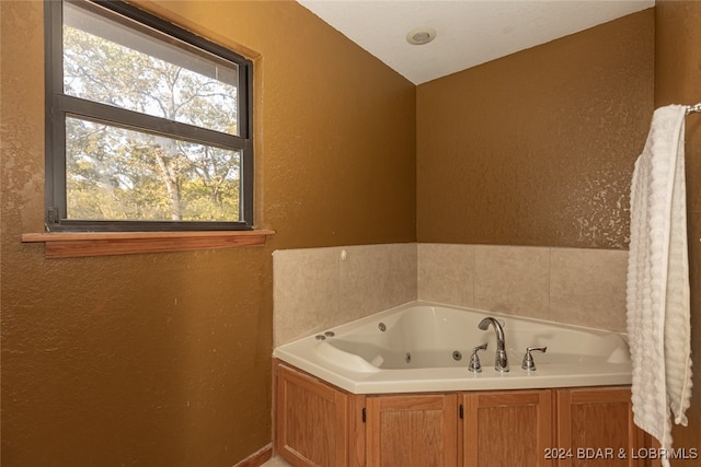 bathroom featuring a bathtub and vaulted ceiling