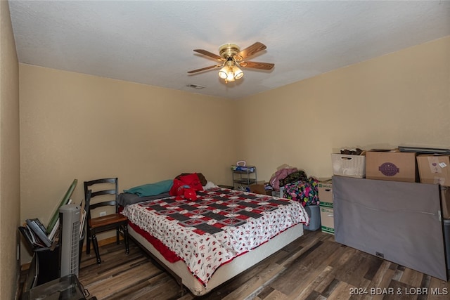 bedroom featuring ceiling fan and dark hardwood / wood-style flooring