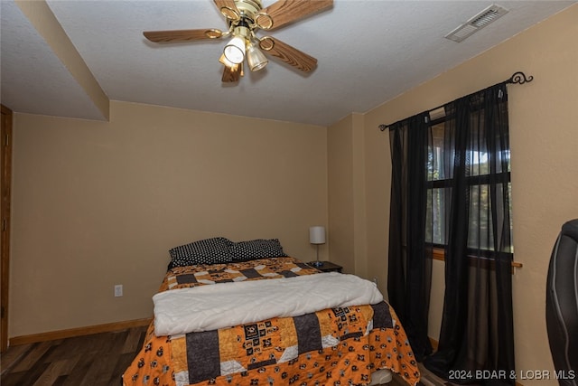 bedroom with ceiling fan and hardwood / wood-style flooring