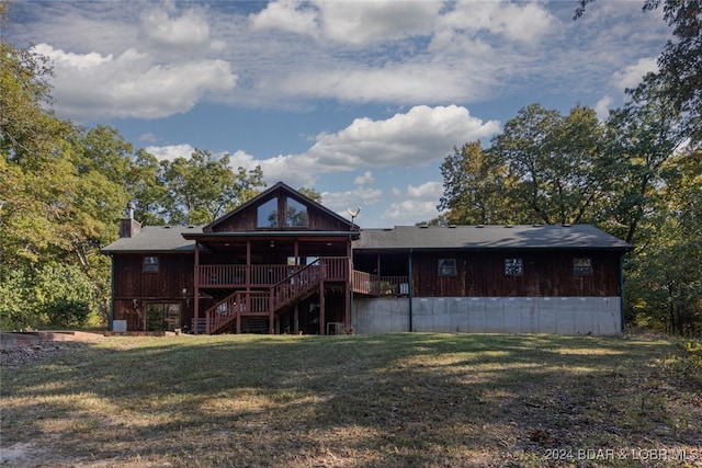 back of house featuring a yard and a wooden deck