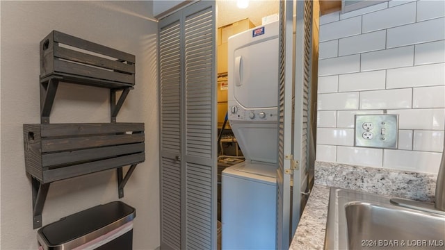 laundry area featuring stacked washer and clothes dryer