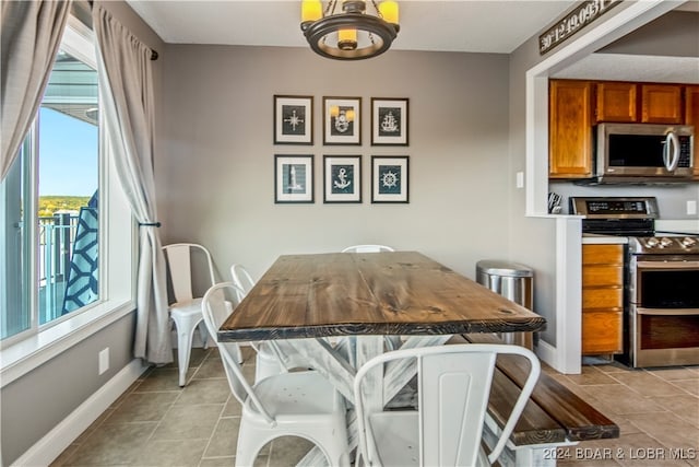 dining area with an inviting chandelier and light tile patterned floors