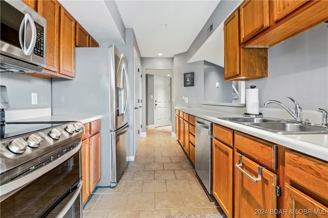 kitchen featuring light tile patterned floors, sink, and stainless steel appliances