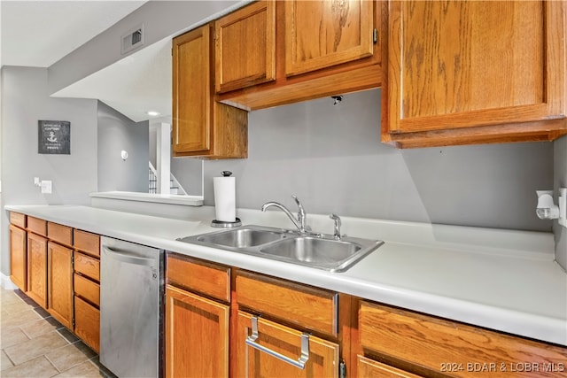 kitchen with light tile patterned floors, dishwasher, and sink