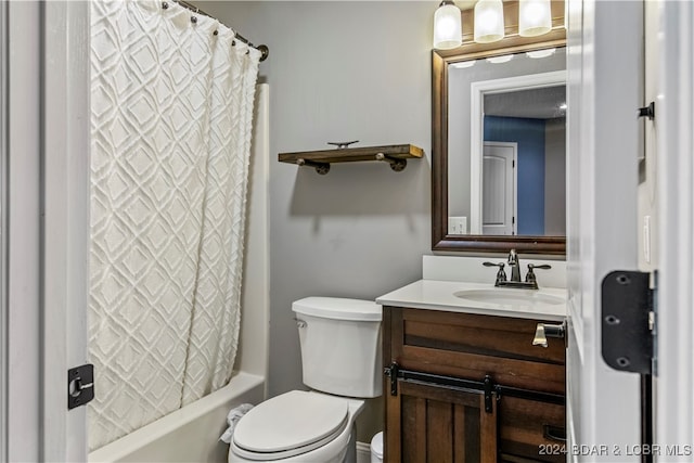 full bathroom featuring shower / bath combo, vanity, and toilet