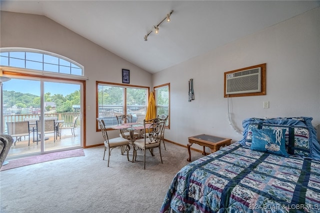 bedroom with multiple windows, a wall unit AC, vaulted ceiling, and access to outside