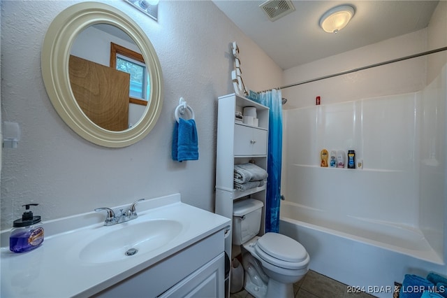 full bathroom featuring tile patterned floors, vanity, shower / tub combo with curtain, and toilet