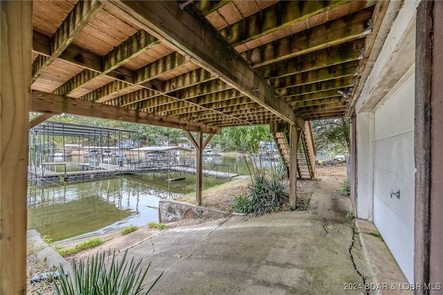 view of patio featuring a water view and a boat dock