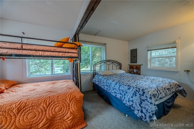 carpeted bedroom featuring electric panel and beam ceiling