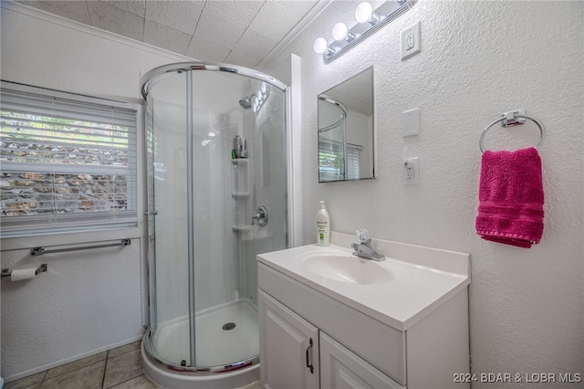 bathroom featuring tile patterned floors, walk in shower, and vanity