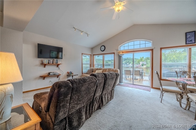 living room featuring lofted ceiling, ceiling fan, track lighting, and light carpet