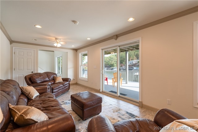 living room featuring crown molding, tile patterned floors, and ceiling fan