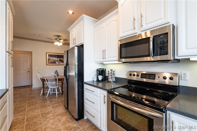 kitchen with crown molding, ceiling fan, white cabinetry, and stainless steel appliances