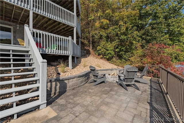 view of patio / terrace featuring a fire pit and a deck