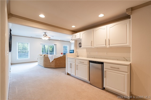 kitchen with ornamental molding, stainless steel refrigerator, white cabinetry, and light colored carpet