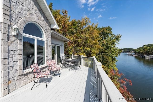 wooden terrace featuring a water view