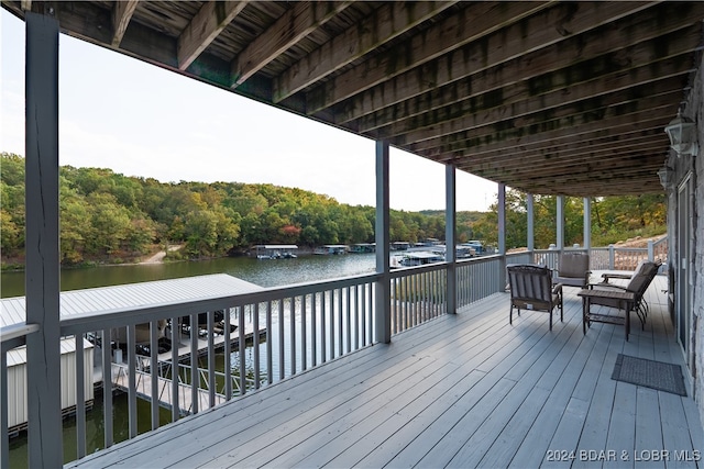 wooden terrace featuring a water view