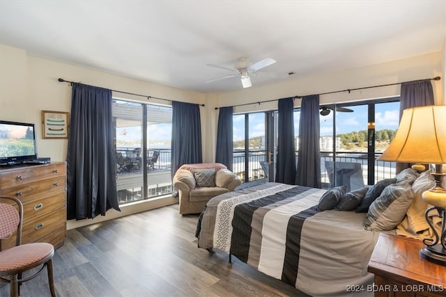 bedroom with dark hardwood / wood-style floors, access to exterior, and ceiling fan