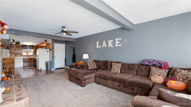 living room featuring ceiling fan, tile patterned flooring, and beam ceiling