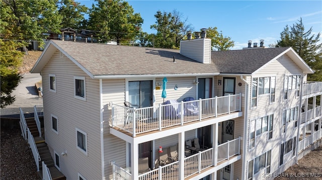 back of house featuring a balcony