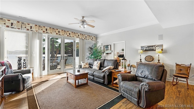 living room with french doors, crown molding, and hardwood / wood-style flooring