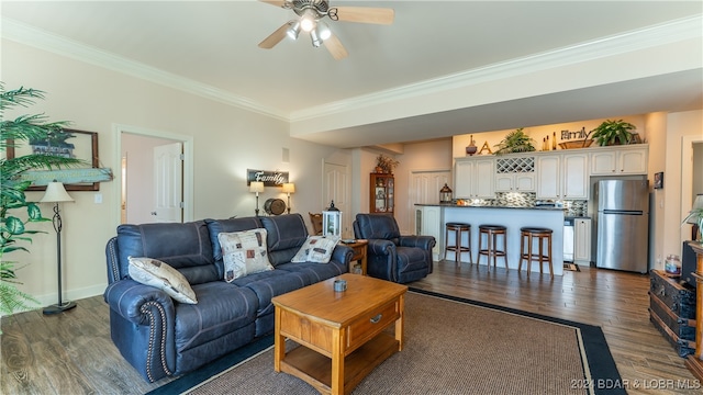 living room featuring ornamental molding, ceiling fan, and dark hardwood / wood-style flooring