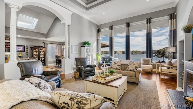 living room featuring crown molding, a water view, a healthy amount of sunlight, and hardwood / wood-style flooring