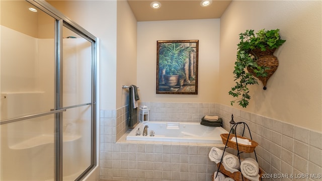 bathroom featuring independent shower and bath