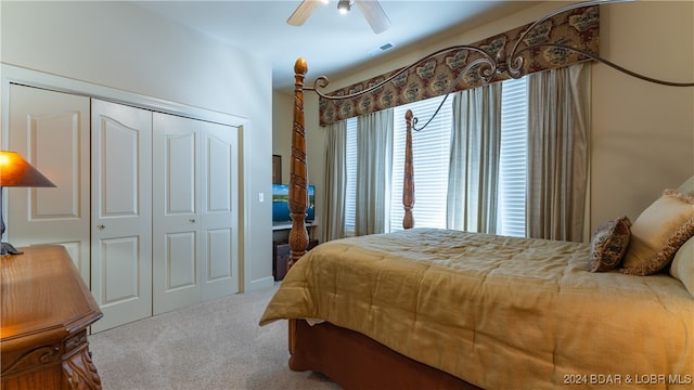 carpeted bedroom featuring a closet and ceiling fan