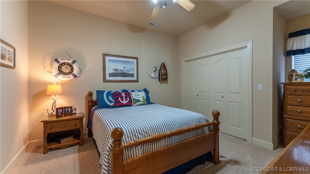 bedroom featuring light carpet, a closet, and ceiling fan