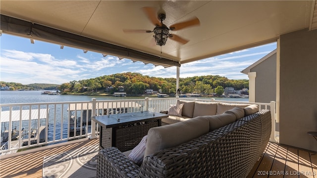 exterior space featuring an outdoor living space, a water view, and ceiling fan