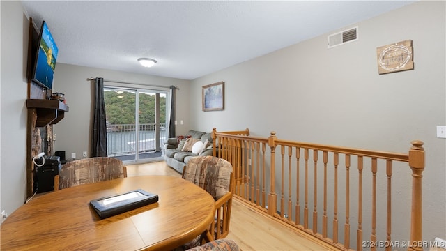 dining room with visible vents and wood finished floors