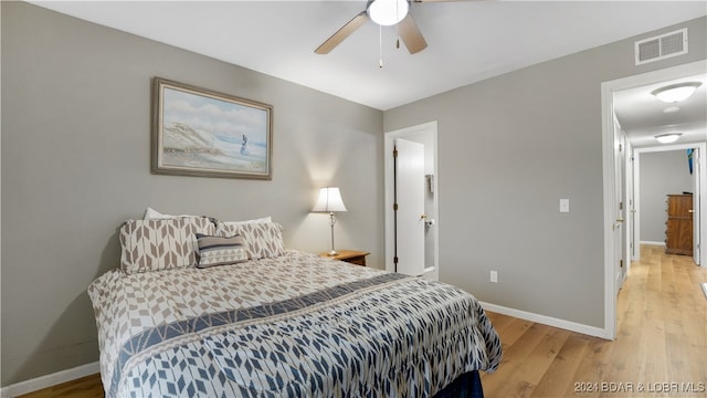 bedroom with a ceiling fan, baseboards, visible vents, and light wood-type flooring