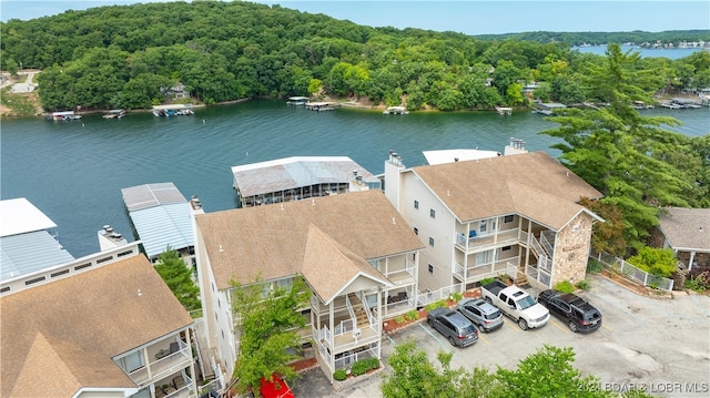 bird's eye view with a forest view and a water view