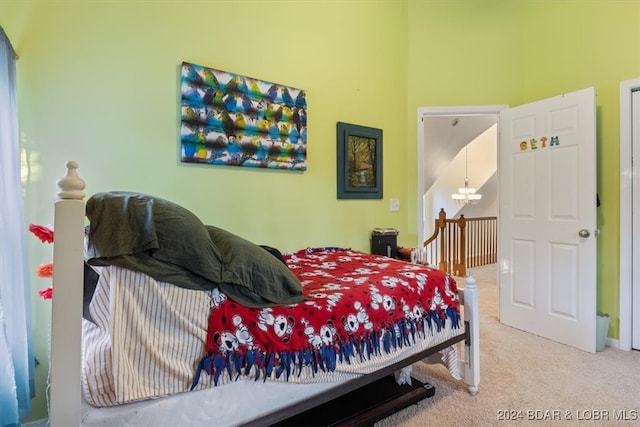 bedroom with carpet and a chandelier