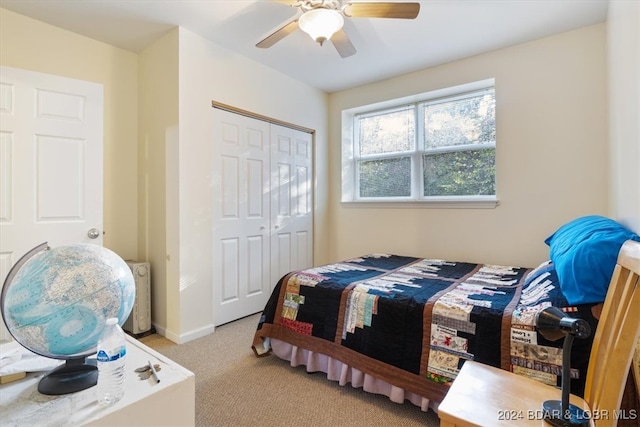 bedroom featuring light carpet, a closet, and ceiling fan