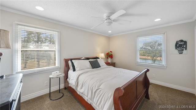 bedroom featuring dark carpet, ornamental molding, a textured ceiling, and ceiling fan