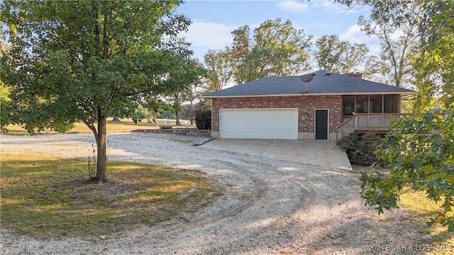 3 Willow Rd, Eldon, MO 65026 - view of property exterior featuring a sunroom, dirt driveway, a garage, and brick siding