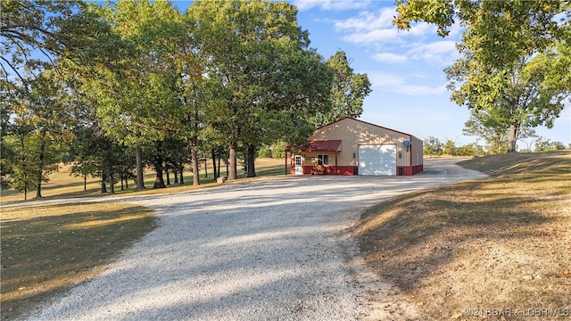 view of side of property featuring an outdoor structure and a garage