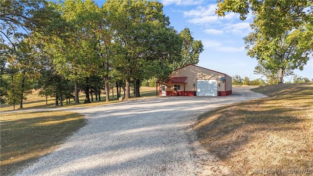 3 Willow Rd, Eldon, MO 65026 - view of home's exterior featuring a garage, an outbuilding, and gravel driveway