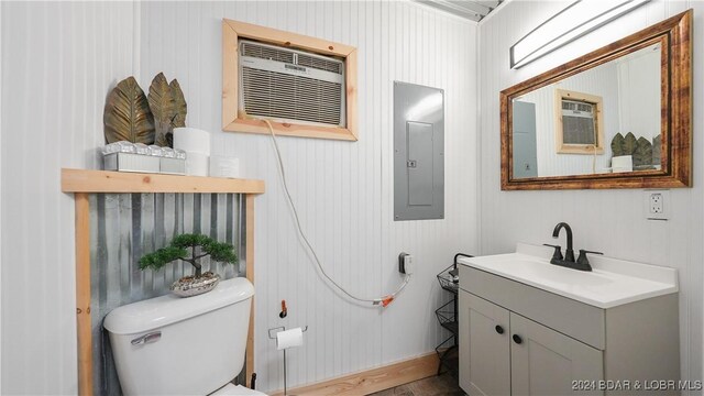 3 Willow Rd, Eldon, MO 65026 - bathroom with electric panel, toilet, vanity, wood finished floors, and a wall mounted AC