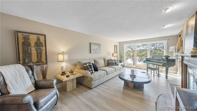 3 Willow Rd, Eldon, MO 65026 - living area with a textured ceiling, wood finished floors, and baseboards