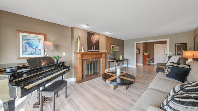 living room featuring light hardwood / wood-style flooring and a textured ceiling