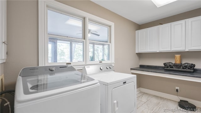 laundry area with cabinets and washing machine and clothes dryer