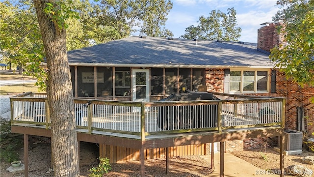 back of house with a sunroom, a deck, and central AC unit